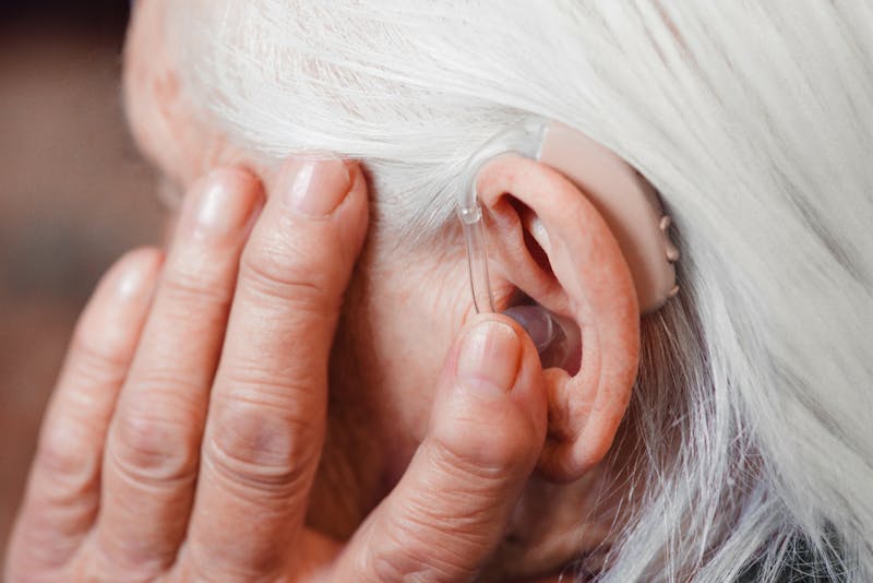 senior using a hearing wearable device